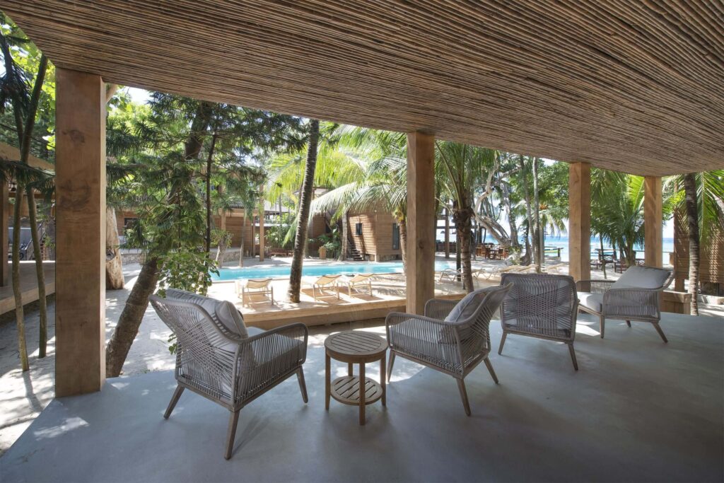 A poolside lounge at Arca - a sustainably run Roatan hotel