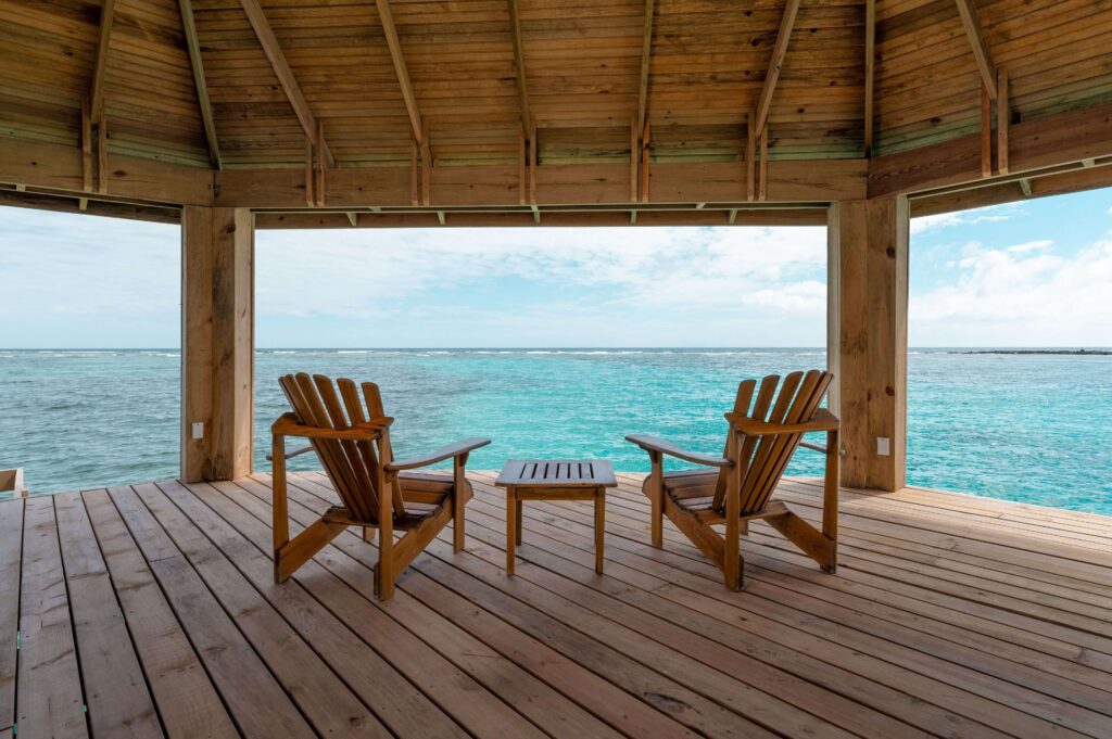 Deck chairs looking out across the Caribbean Sea at Barefoot Cay Resort