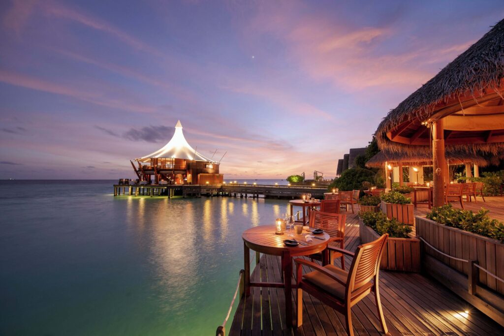 A candlelit dining space at the sustainably run Baros Maldives