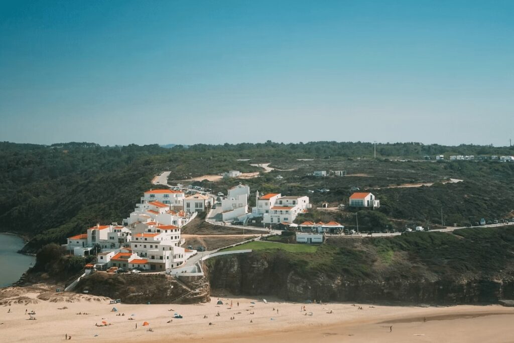 A whitewashed town cascades down to the coast at one of the best places to surf in Portugal