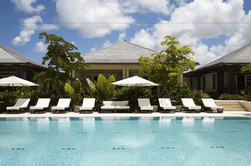 Sun loungers beside a swimming pool at The Island House, an eco-friendly hotel in the Bahamas 