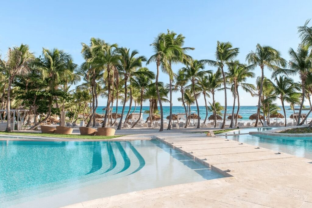 Palm trees fringe a lagoon-like pool at Eden Roc Cap Cana in the Dominican Republic