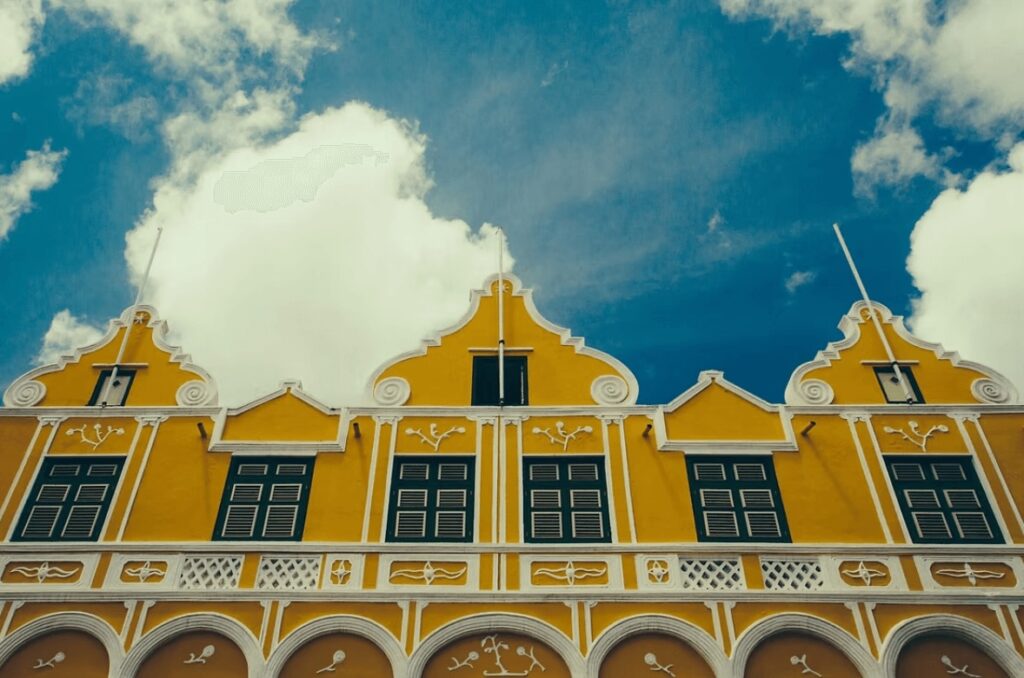 Best places to dive in the Caribbean: A bright yellow colonial building in Curaçao