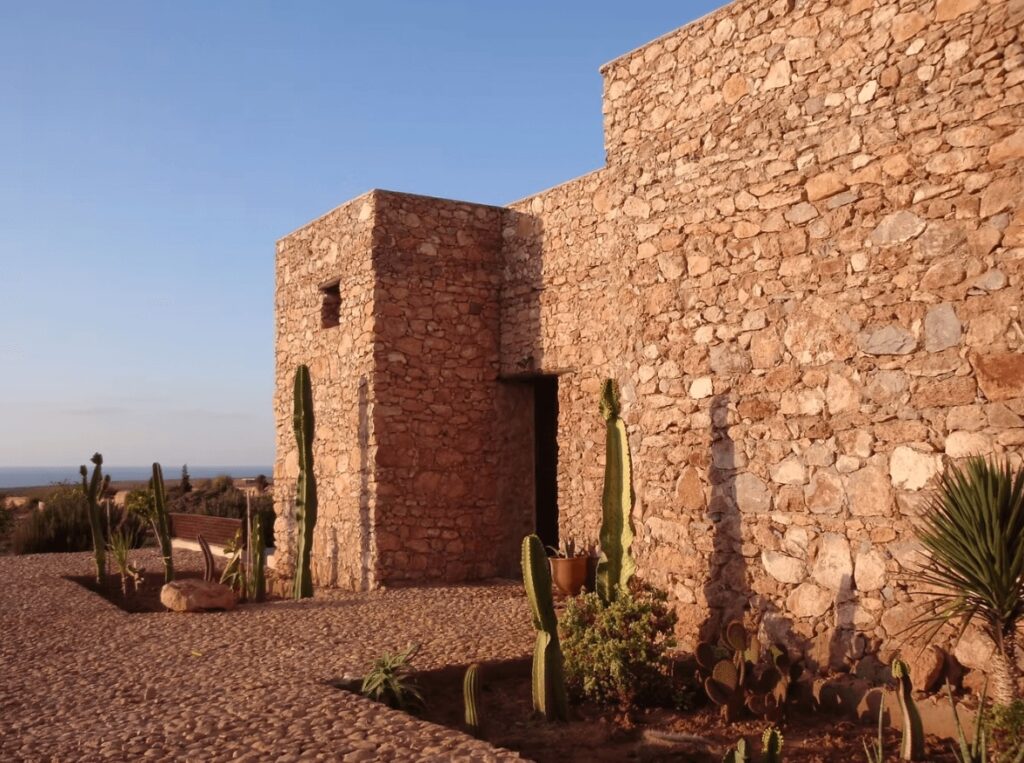 The stone-built exterior of Kasbah Tabelkoukt, one of the best places to stay in Mirleft, Morocco 