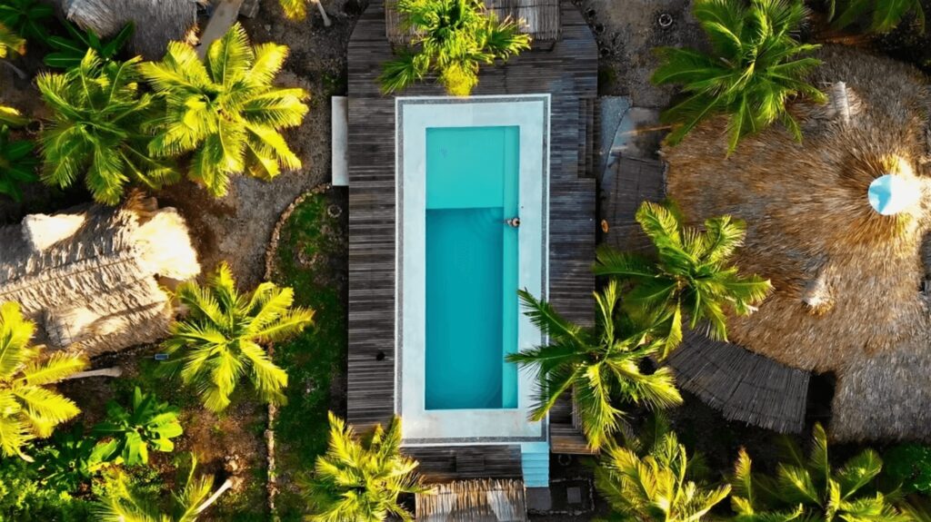 A bird's eye view of the swimming pool at Wiji Island House, an eco-friendly hotel on Isla Fuerte