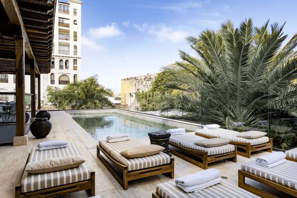 Sun loungers beside a pool at the Eurostars Marqués de Villalta, an eco-friendly hotel in Cartagena