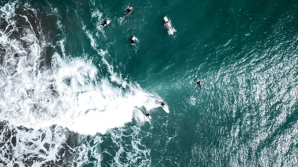 An aerial view of boardriders at one of the best surf breaks in Peru