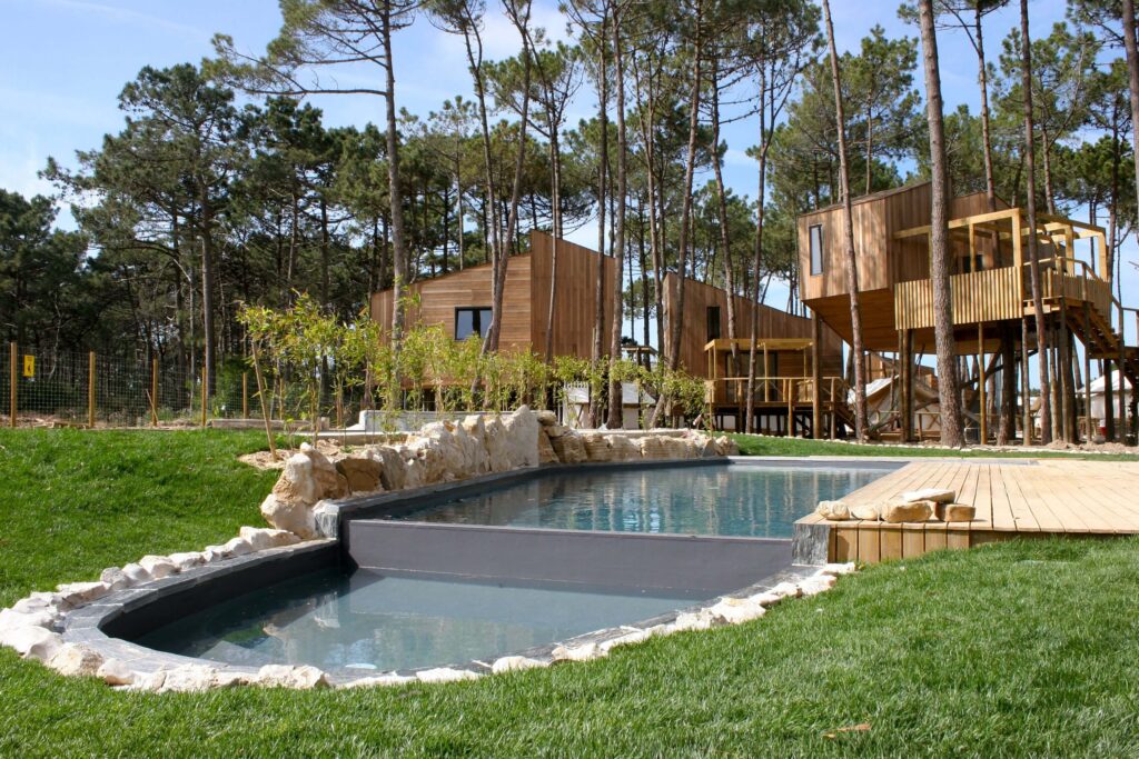 The swimming pool and stilted cabins at Bukubaki Eco Surf