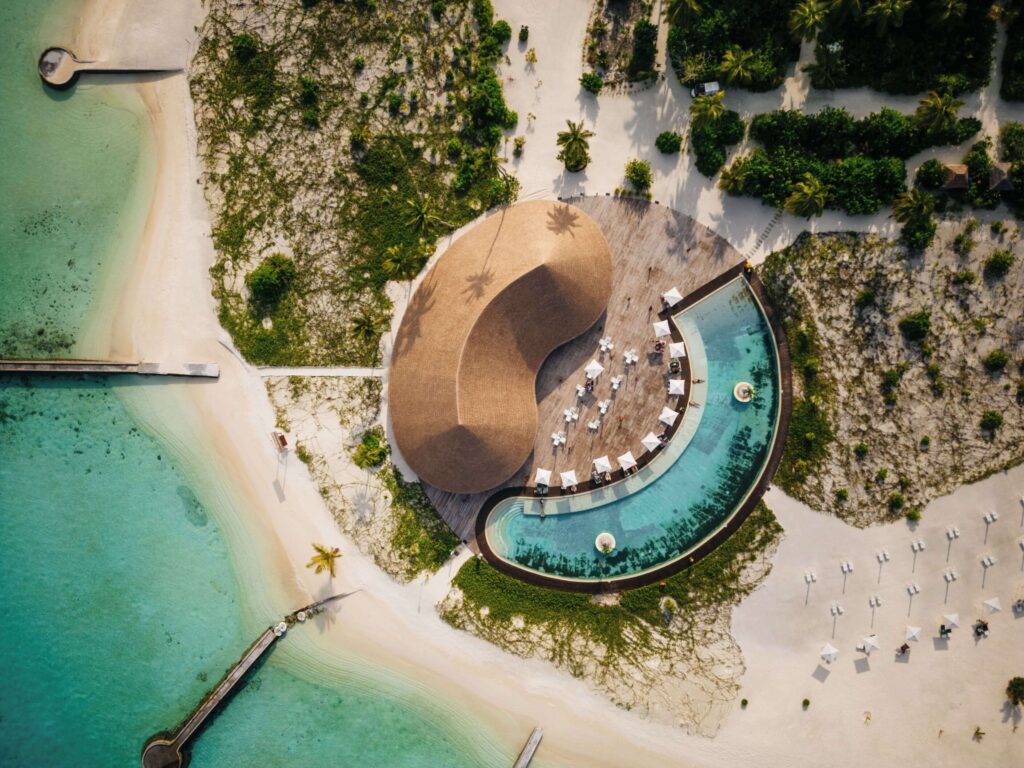 An aerial view of a beachside swimming pool at Cinnamon Velifushi Maldives
