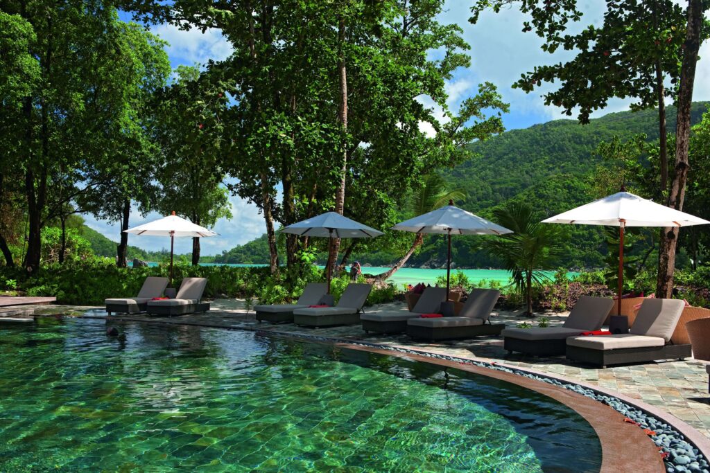 Sun loungers beside the swimming pool at Constance Ephelia in the Seychelles