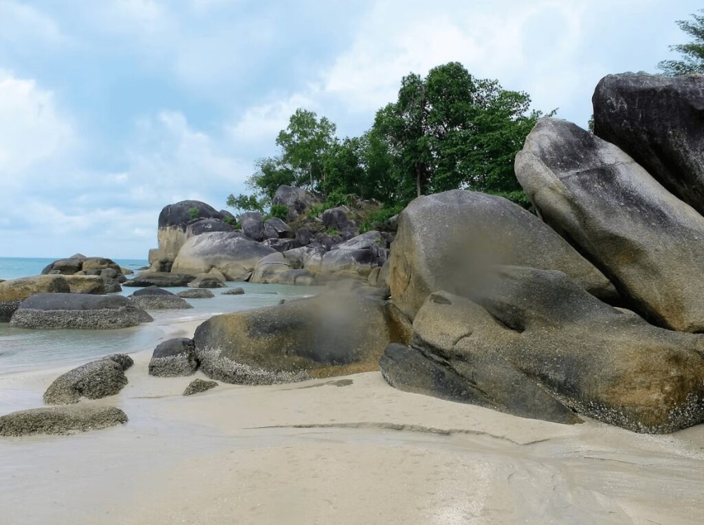 Eco-dive resorts in Indonesia: Large boulders on a beach on Bangka Island in Sulawesi