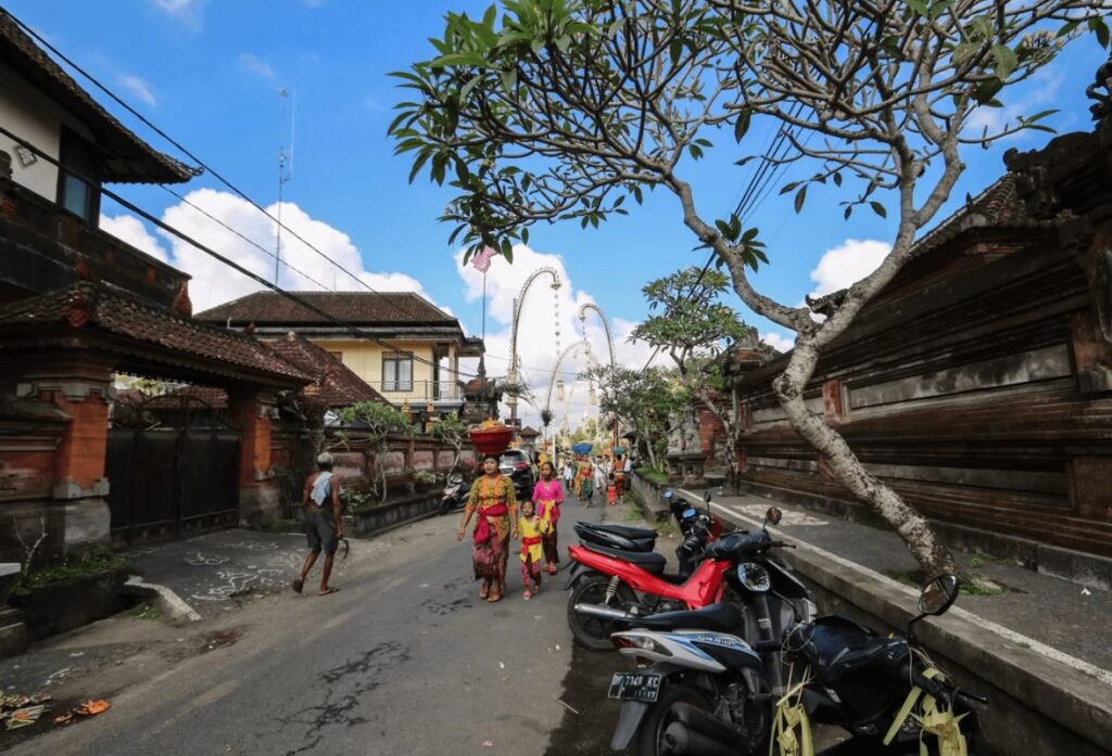 Best eco-friendly resorts in Bali: Traditionally dressed locals on a neighbourhood street