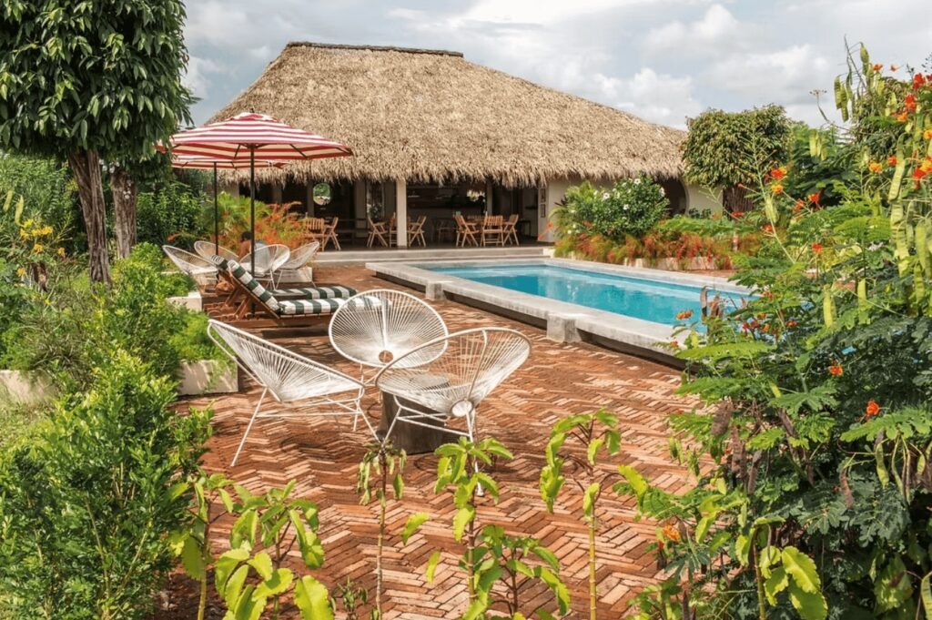 An outdoor pool surrounded by greenery at Malibu Popoyo, one of the best eco-lodges in Nicaragua
