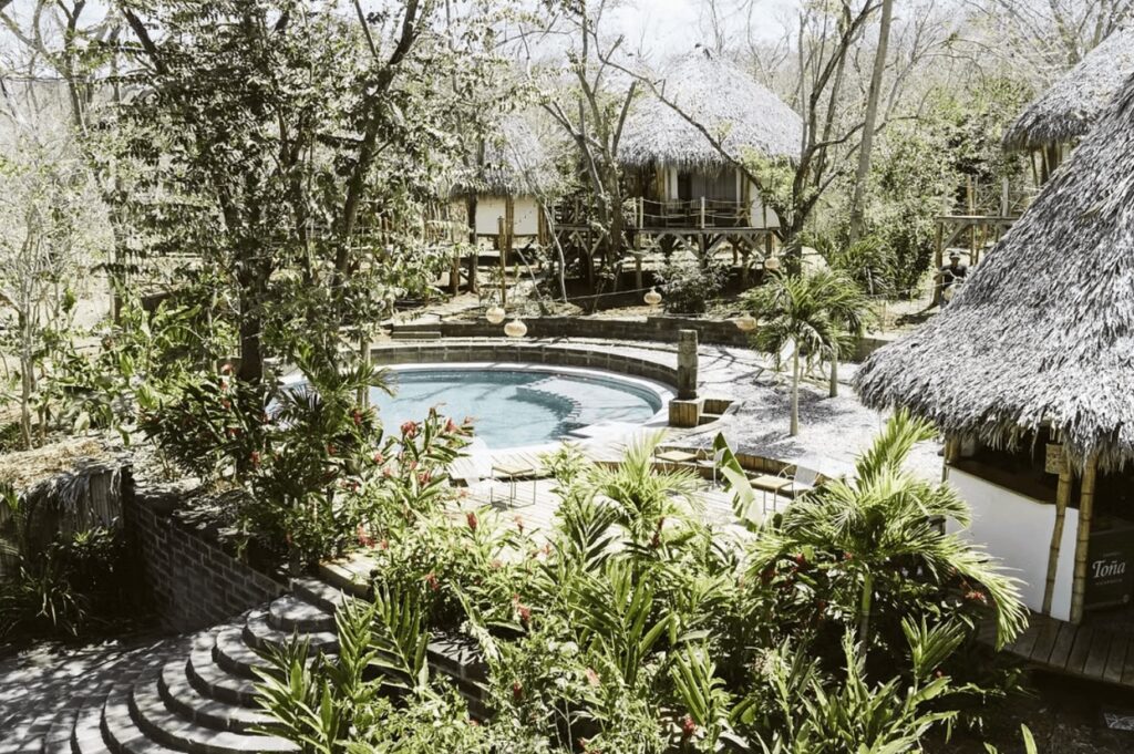A circular pool in the leafy grounds of the DreamSea Surf Resort, an eco-friendly resort in San Juan del Sur