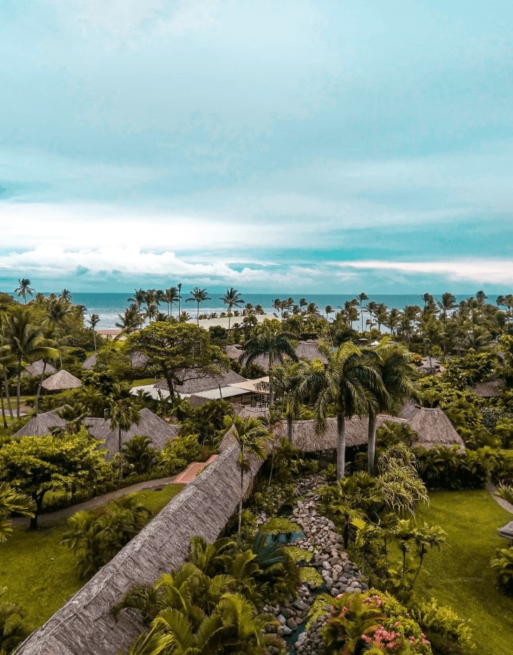 Thatched roof buildings at an eco-friendly surf resorts in Fiji