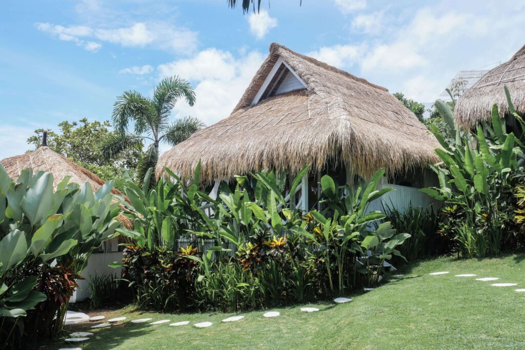 Stepping stones lead between the thatched roof bungalows at Gravity Eco Boutique Hotel
