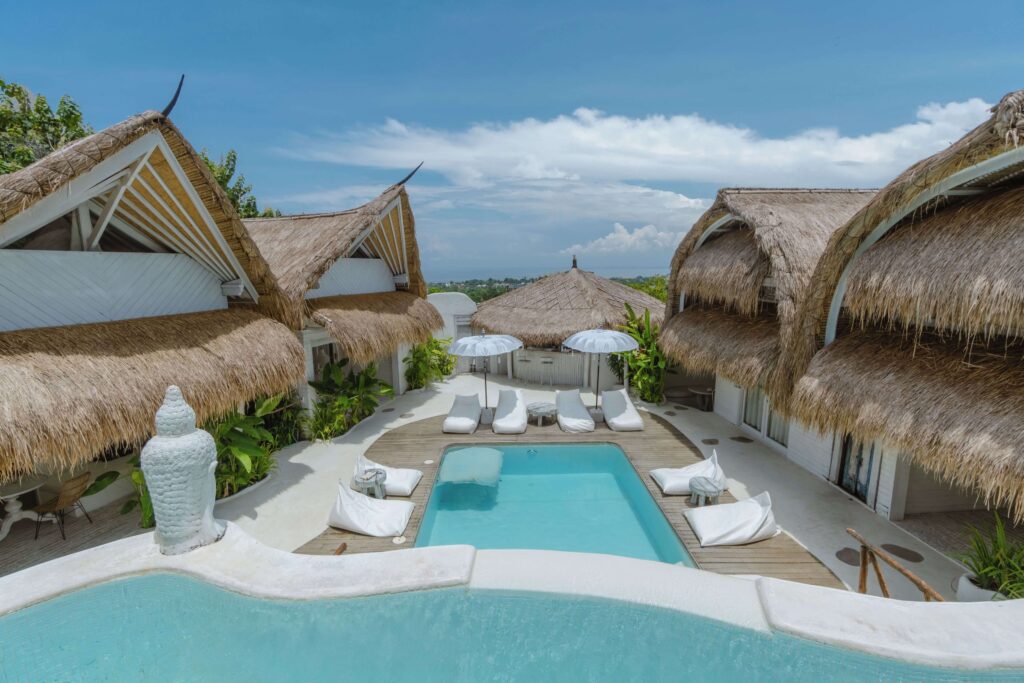 Bungalows surround the multi-tiered swimming pool at Gravity Eco Boutique Hotel in Uluwatu