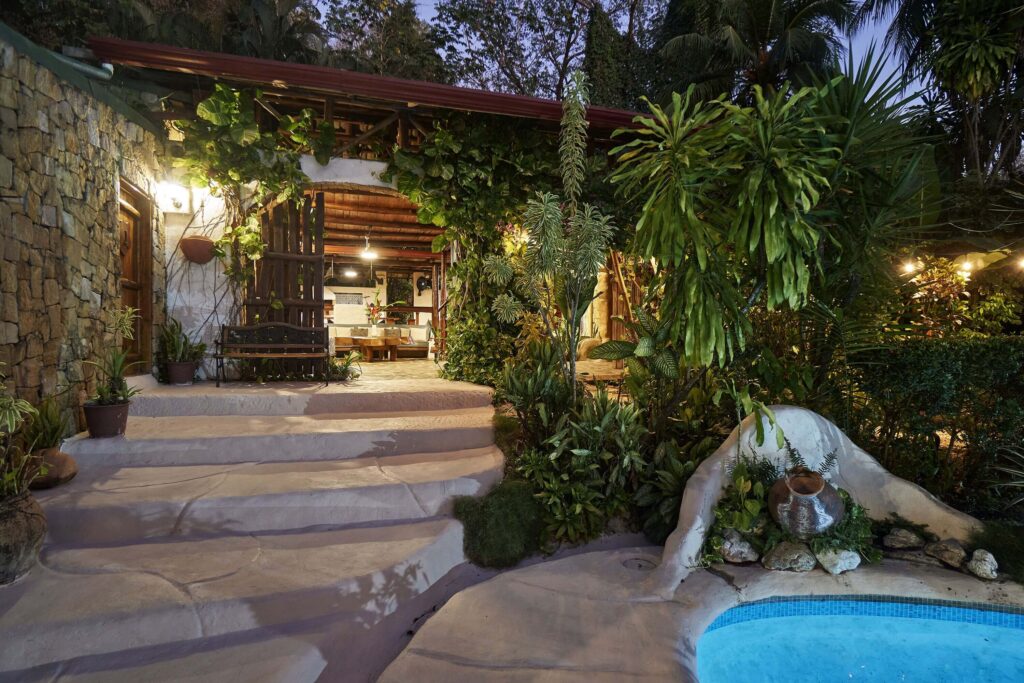 Steps lead down to the swimming pool at Havana Lodge - an eco-friendly hotel in Santa Teresa