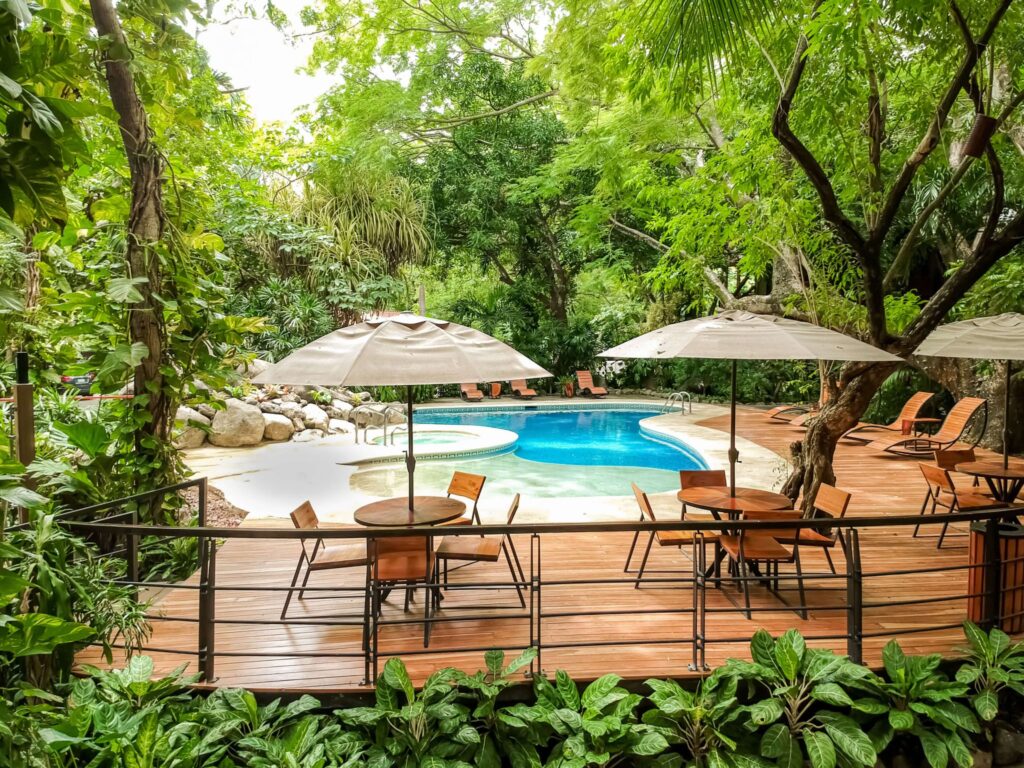 A swimming pool and dining deck at Hotel Bosque del Mar in Playa Hermosa, Costa Rica