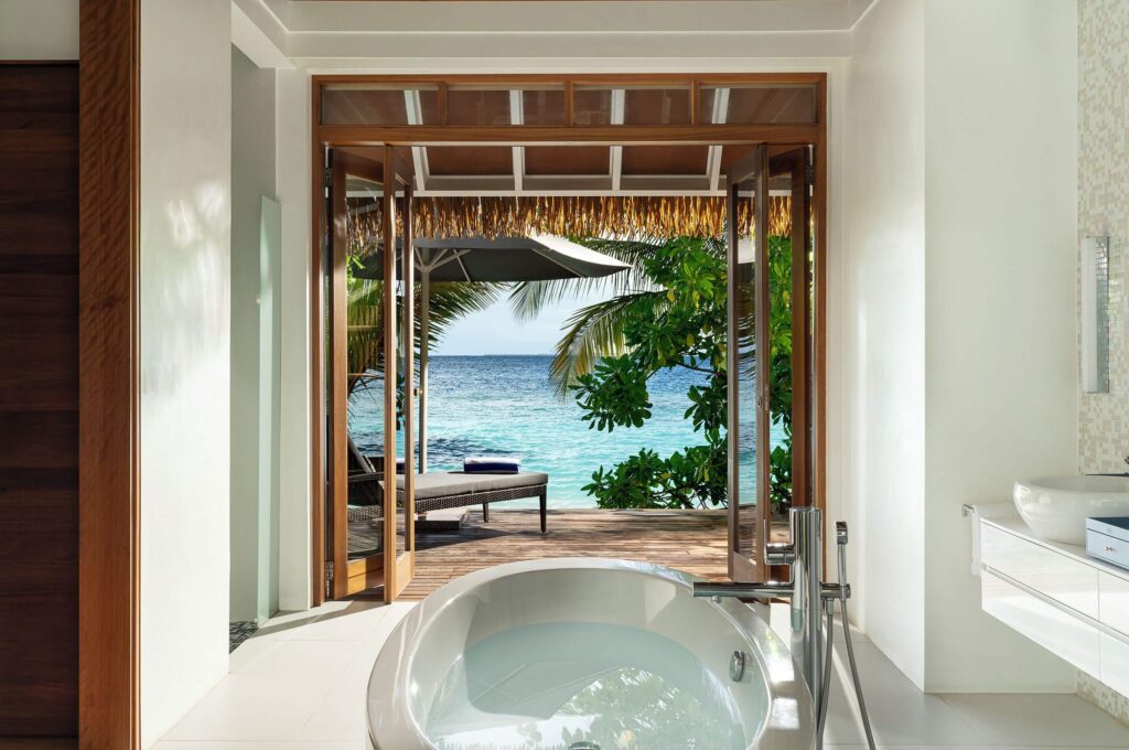 Views from a spa bath in one of the villas at Kandolhu Maldives