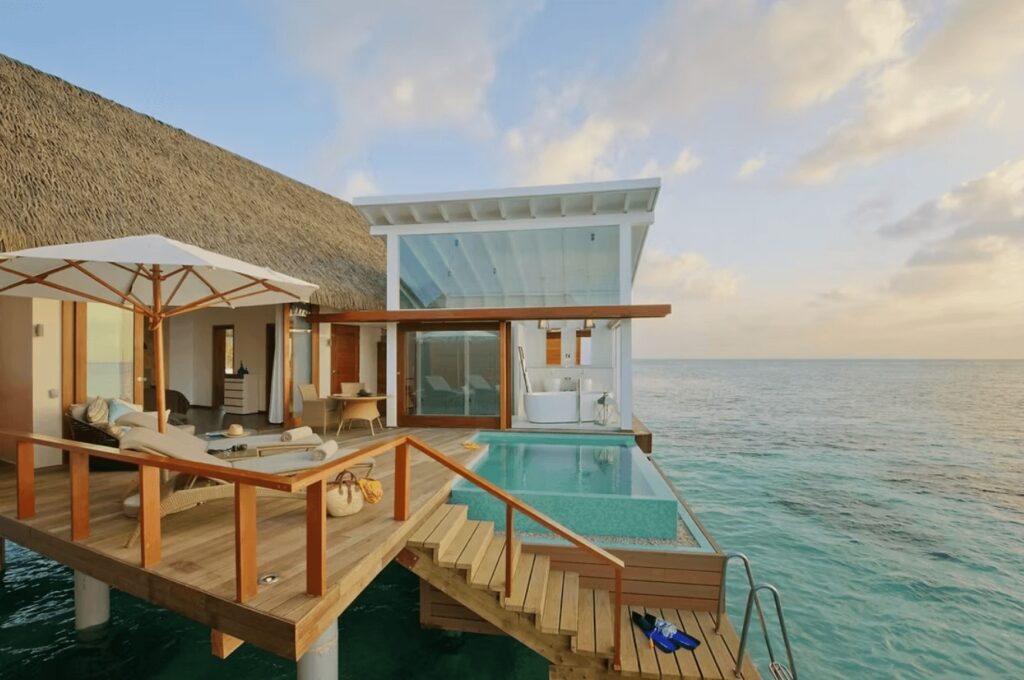 An overwater villa with a private pool at Kandolhu Maldives, one of the best eco-friendly resorts in the Maldives