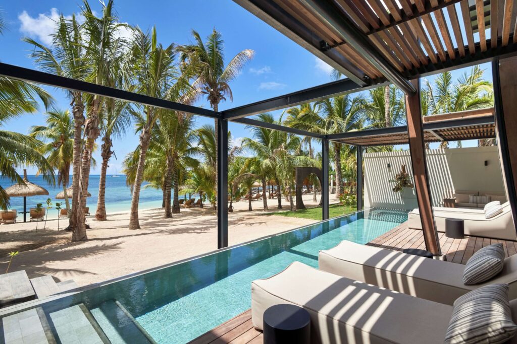 Lounges beside a beachfront pool at LUX* Grand Baie in Mauritius
