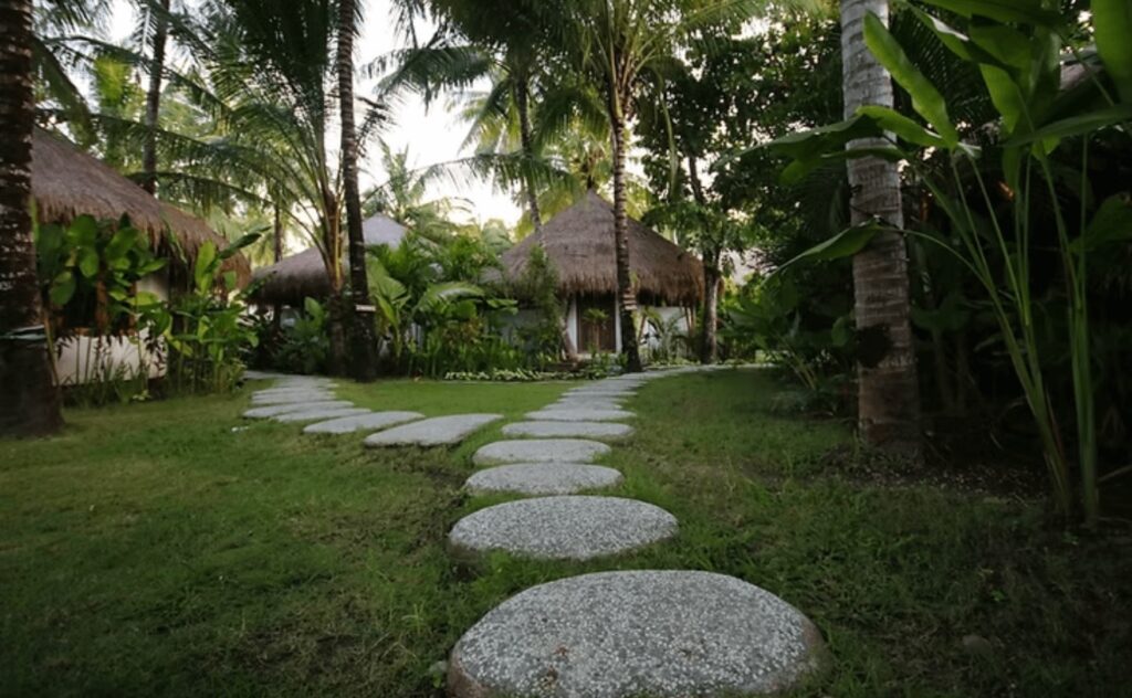 Best surf and yoga retreats in Lombok: A stone path leads through the grounds of Mana Eco Retreat & Yoga