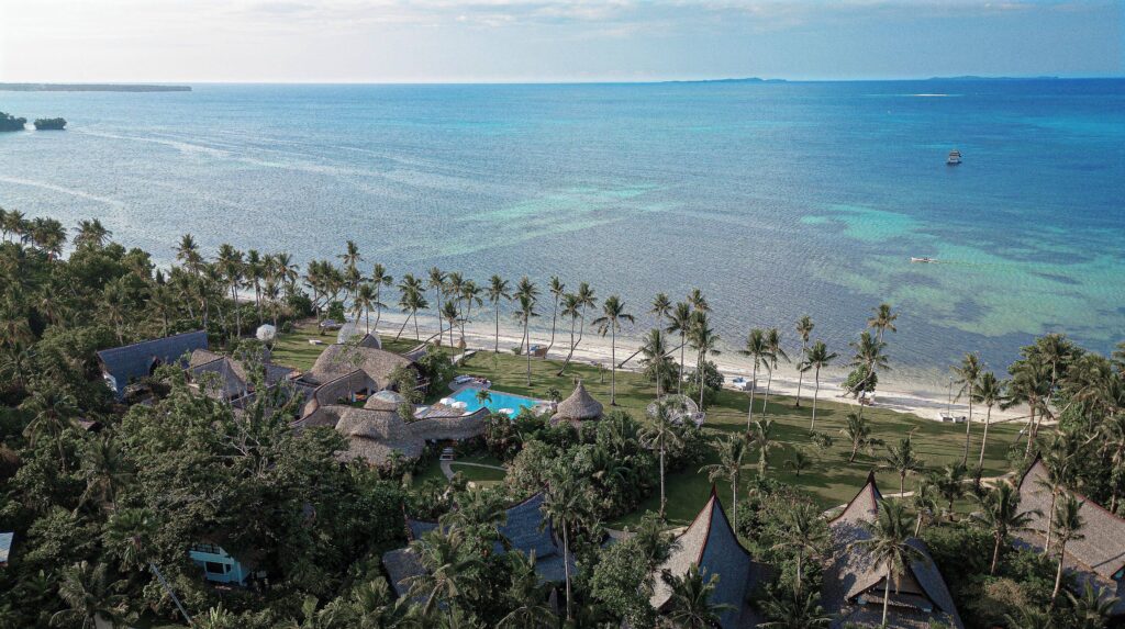 A bird's eye view of the palm-studded grounds of Nay Palad Hideaway - a luxury resort in Siargao