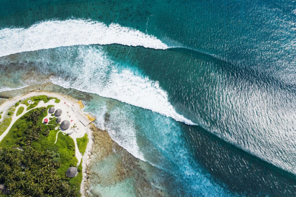 Waves breaking alongside the Niyama Resort - one of the best places to stay for surfers in the Maldives