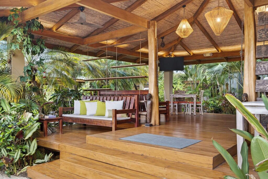 A leafy lounge at Ocio Villas Mal Pais - a sustainable hotel in Santa Teresa
