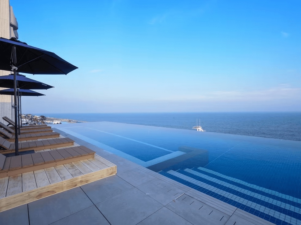 Sun loungers beside the infinity pool at the Oiso Prince Hotel in Kanagawa Prefecture, Japan
