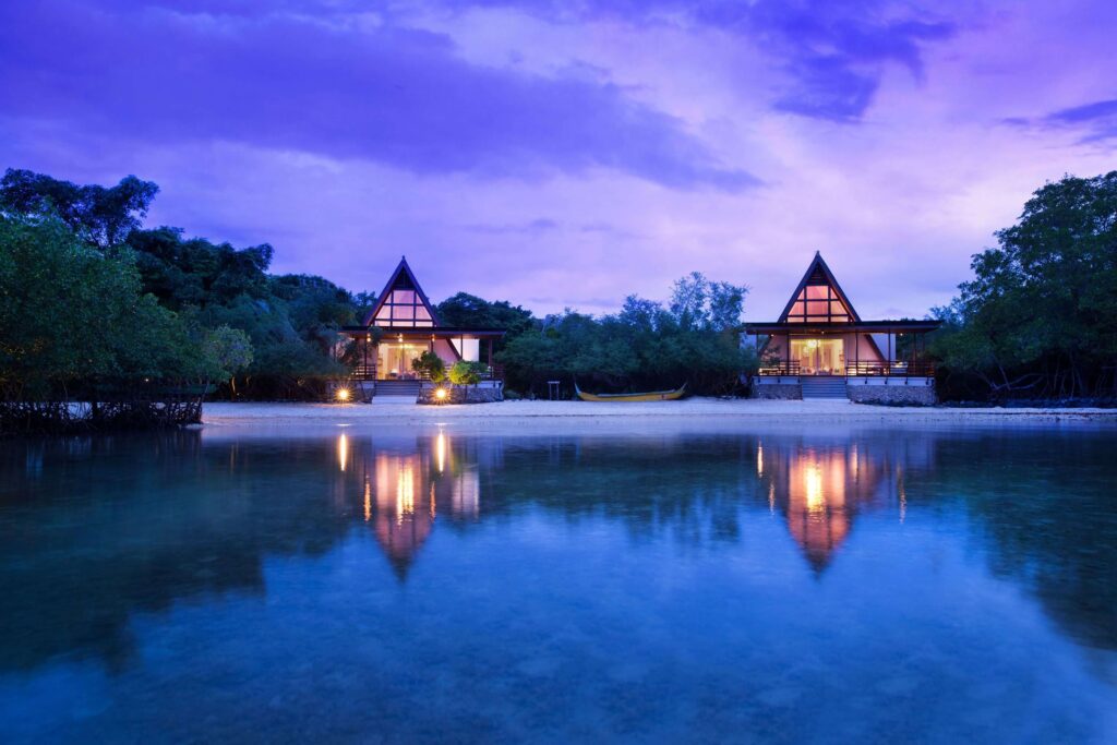 A-frame villas reflected in the water at Plataran Menjangan Resort & Spa