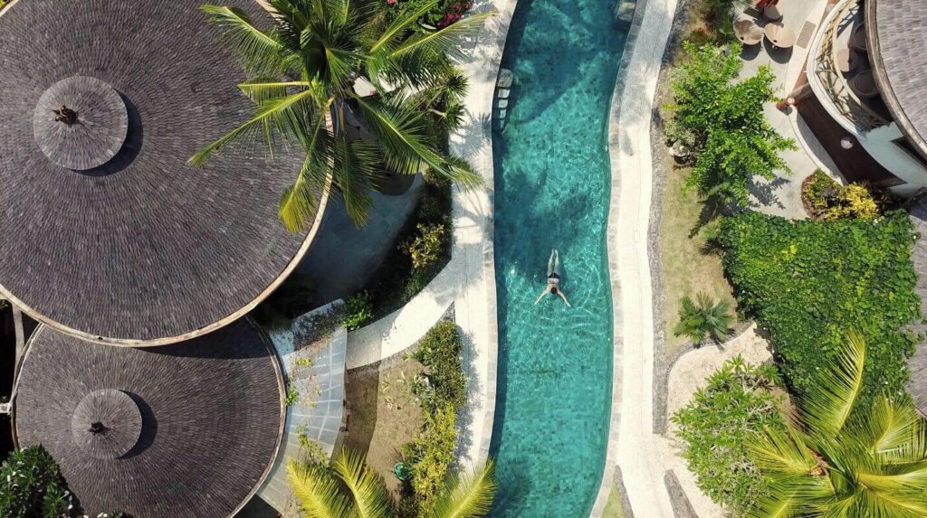 A bird's eye view of the lazy river swimming pool at Puri Dajuma Beach Eco-Resort & Spa