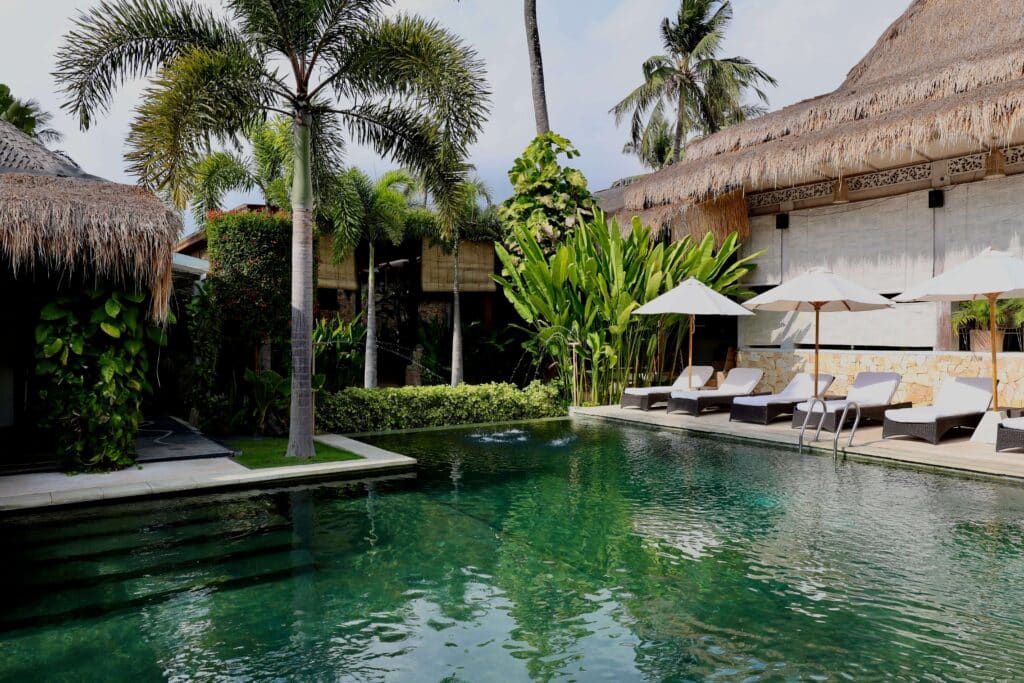 Sun loungers beside the central pool at Rascals in Kuta, Lombok