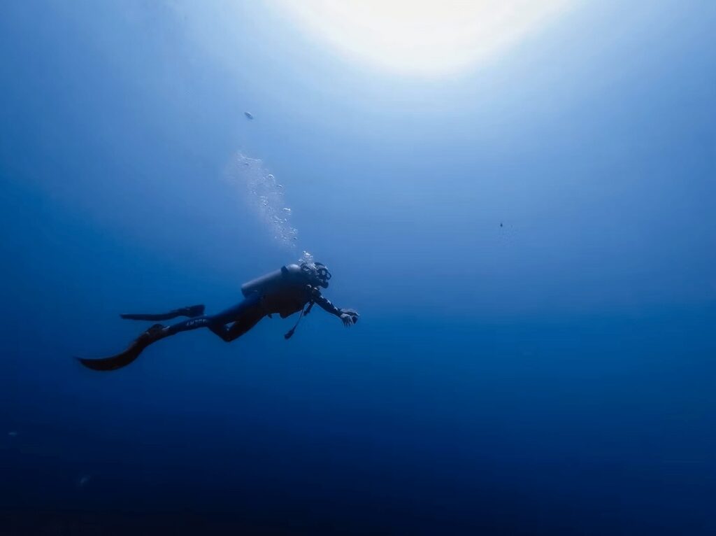 A scuba diver explores the deep blue on a Tubbataha Reefs liveaboard trip
