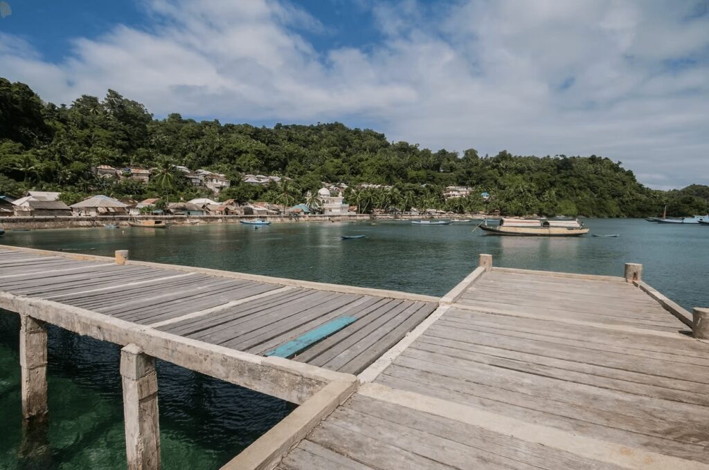 Best places to dive in Indonesia: A wooden jetty extends into the water in the Banda Islands