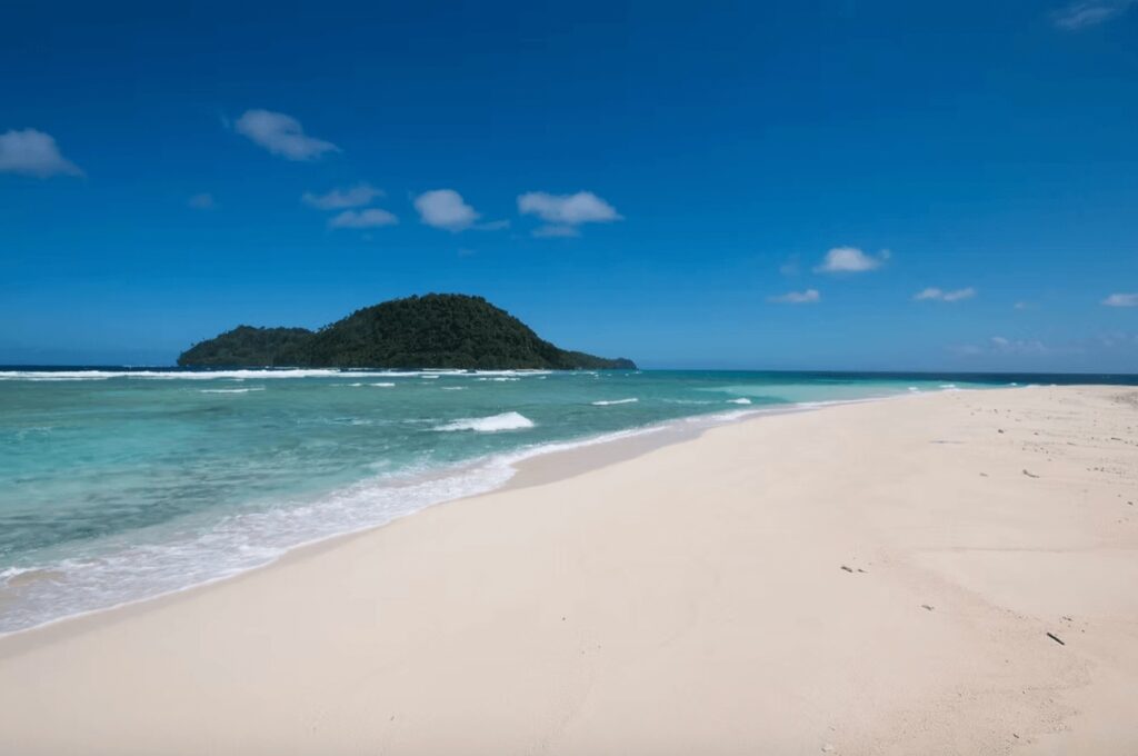 Best places to dive in Indonesia: An island backs a white sandy beach