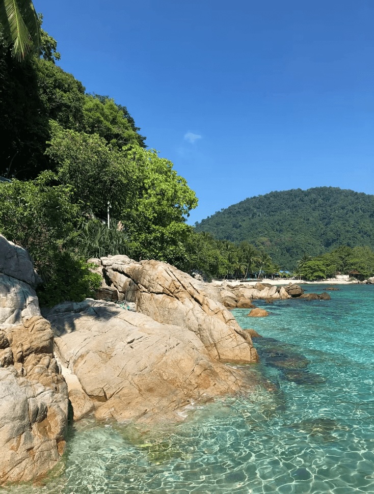 Scuba diving in Malaysia: A rocky coastline lapped by the crystal clear waters of the South China Sea