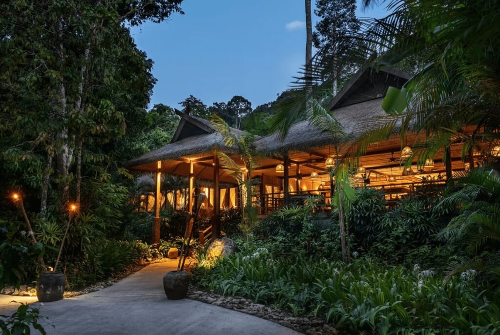 An illuminated restaurant at The Datai Langkawi, one of the best eco-friendly resorts in Malaysia 
