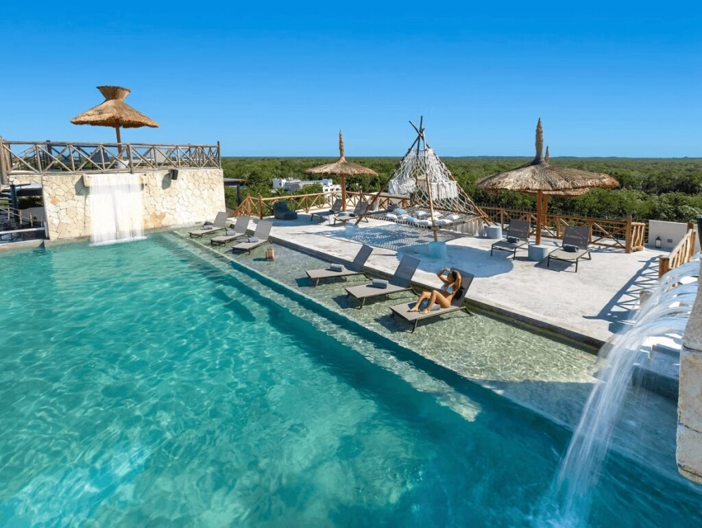 Waterfalls cascade into a rooftop pool at Naala Tulum on Mexico's Riviera Maya