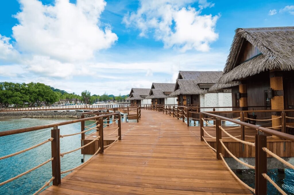 A wooden boardwalk leads between the overwater bungalows at Palau Pacific Resort 