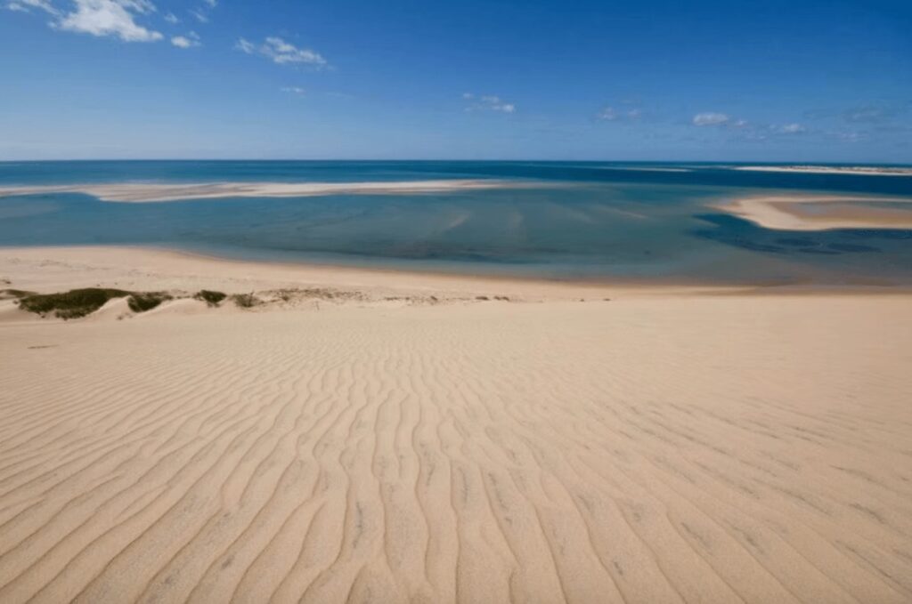 Surfing in Mozambique: A wind-sculpted dune descends to the Indian Ocean in the Bazaruto Archipelago