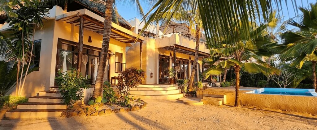 Sunset illuminates the beachfront accommodation at Milele Villas, an eco-friendly hotel in Zanzibar 