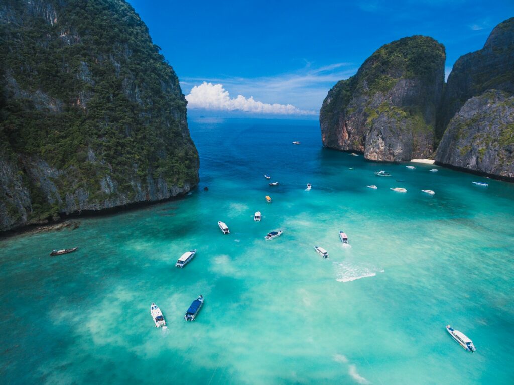 Scuba diving in Thailand: An elevated view of boats between towering limestone islands