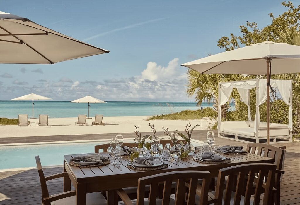 Alfresco dining poolside at COMO Parrot Cay, an eco-friendly hotel in Turks and Caicos