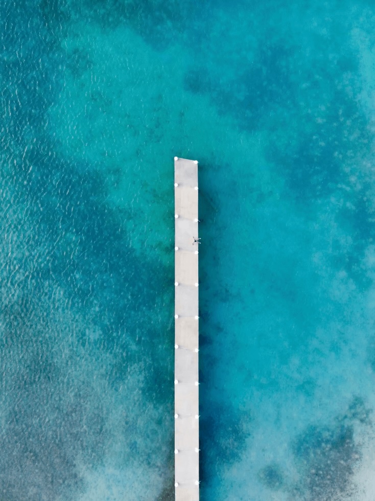A jetty extends into the Caribbean Sea in Turks and Caicos, one of the best dive spots in the Caribbean