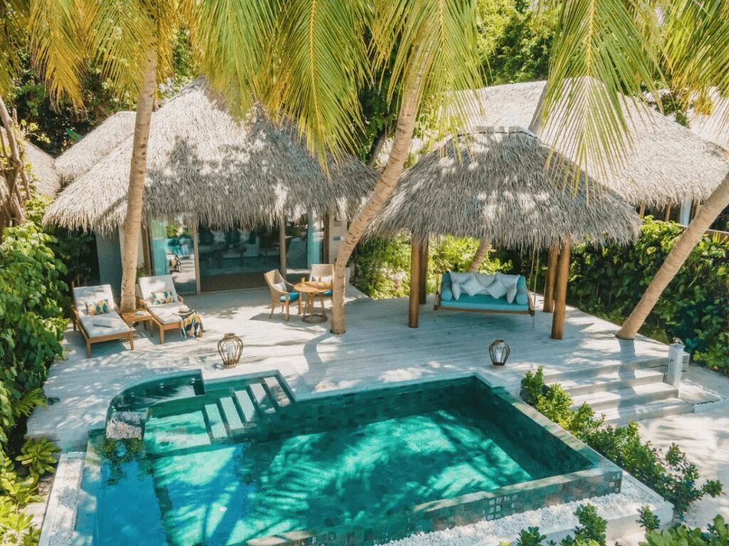 A thatched roof suite with a private pool at Baros Maldives, an eco-friendly resort in the Maldives 