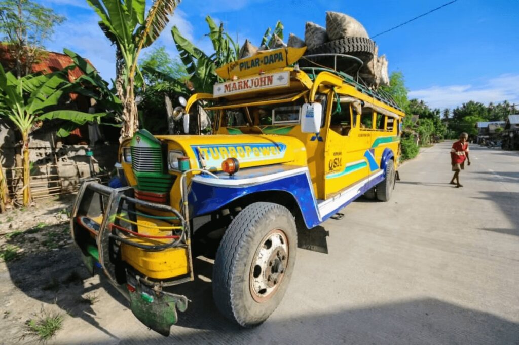 Best places to dive in the Philippines: A bright yellow jeepney bus