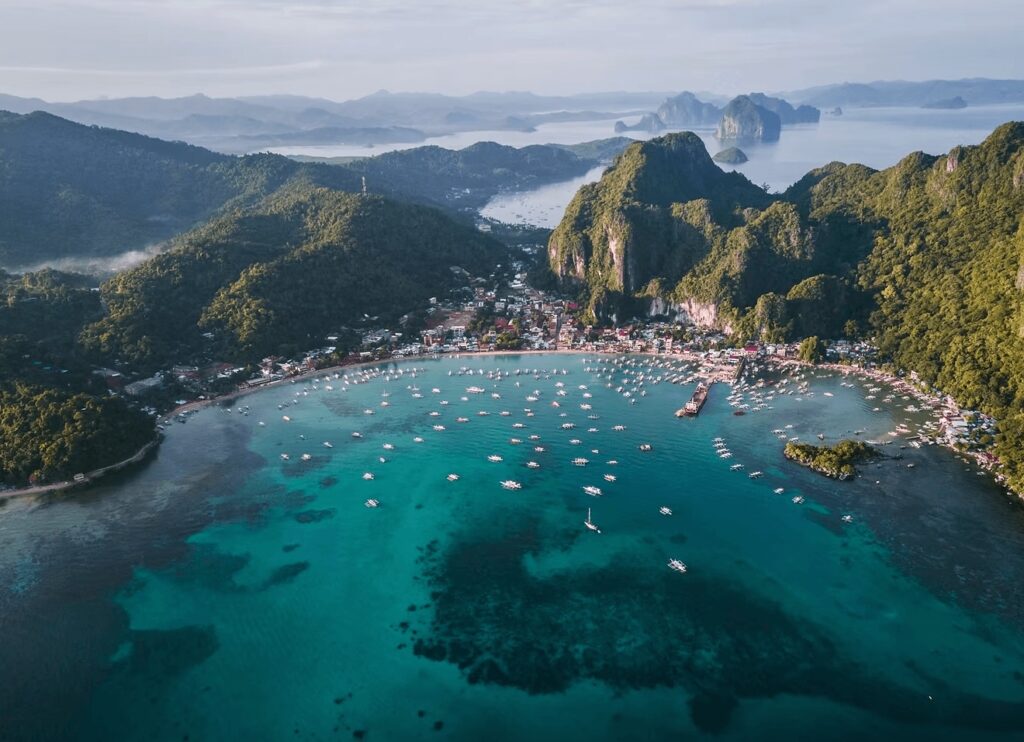 Scuba diving in the Philippines: An elevated view of boats dotting a bay in Coron