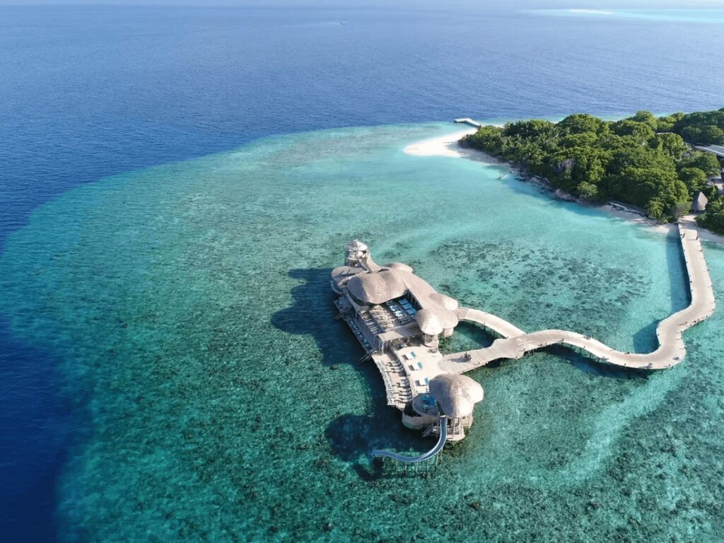 A bird's eye view of an overwater restaurant at Soneva Fushi, an eco-luxe resort in the Maldives